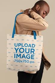 Download Placeit Mockup Of A Young Man Carrying A Tote Bag With Customizable Strap At A Studio Tote Bag Bags Tote Bag Design