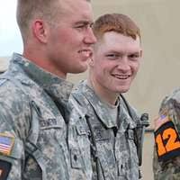Staff Sgt. Paul Martin embraces a fellow soldier of