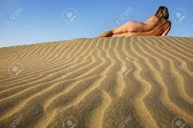 Nude Woman Sunbathing On The Crest Of A Sand Dune Stock Photo, Picture and  Royalty Free Image. Image 962220.