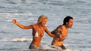 Lily James transforms into Pamela Anderson as she frolics in uncanny beach  wedding scene - The Mirror