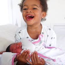 Summer meets her baby sister for the first time