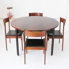 The four chairs in this poker dining table set match the style of the table and have caster wheels so they're easy to move. Set Of Four Chairs Dining Table In Rosewood By Stildomus Italy 1960s 70733