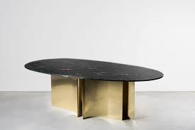 Complete and inviting, relaxed sitting area with the industrial touches of the coffee table. Goldfish Table Analogia Project Nilufar