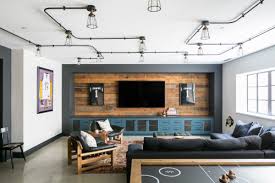 This is an industrial basement living room with an open concept and having recessed lights in a yellowish hue. 10 Trendy Finished Basement Ideas To Inspire Your Project
