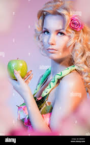 Eva Bible woman holding green apple Photo Stock