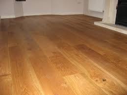Dark walnut hardwood floors are growing in popularity, and look great against a bright trim. Walnut Coloured Brushed Oak Flooring In Family Home