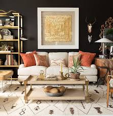 The Oranges Creamy Yellows Off Whites And Browns In This African Inspired Living Room A African Decor Living Room Gold Living Room Brown And Gold Living Room