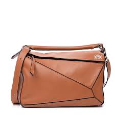 Its top zip closure opens to a tan fabric interior with slip pockets. Loewe Calfskin Medium Puzzle Bag Tan 570106 Fashionphile