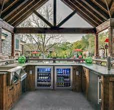 By combining a bar counter and chairs with the grilling station, everyone can visit while the food is sizzling. Top 60 Best Outdoor Kitchen Ideas Chef Inspired Backyard Designs