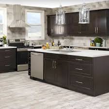 A muted green cabinet color adds depth and interest to the kitchen, while a butler sink and butcher block countertop adds a level of country chic. Shop For Cabinets Countertops Online Home Hardware