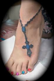 Foot tattoos are limited to small designs, because of the lack of space to draw on. Foot Tattoo Crosses Blue Cross Foot Tattoo Cool Tattoo Ideas Rosary Bead Tattoo Foot Tattoos Bow Tattoo Designs