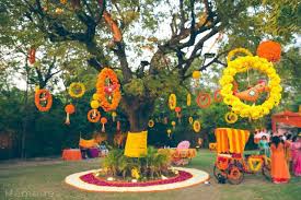 Mehandi Decor With Hanging Flower Rings And Birds Orange And Yellow Mehndi Theme Witty Vows Modern Wedding Decor Flower Decorations Mehndi Decor