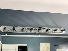 Any ideas on how to easily update the standard builder lights? How To Spray Paint The Ugly Light Fixture In Your Bathroom
