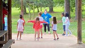 During summer camp, campers gather in the evening and to reflect on what we've learned during the day. Summer Camps Teach Kids About Social Distancing