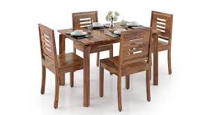Danish furniture inc carries many different shapes, sizes, finishes, and woods for your dining room table and chairs. Catria Capra 4 Seater Dining Table Set Urban Ladder