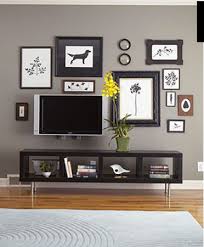 Flat Screen Tv Hung Low On The Wall With A Short Console Table The Tv Become Part Of The Gallery Wall Decor Around Tv Tv Decor Living Room Grey