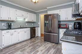 Painting the kitchen cabinets was one change that was at the top of the list. Snowbound Painted Oak Kitchen Cabinets 2 Cabinet Girls