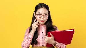 Premium AI Image | AI Generated Young Cute Asian Girl with Glasses Holding  Red Book and Pink Shirt