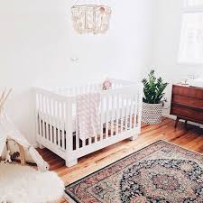 Nursery Wood Floors White Walls Chandelier Persian Rug And Mid Century Furniture Sophisticated Nursery Baby Girl Room Girl Room