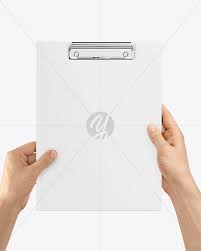 This is a modern and subtle psd clipboard mockup with a straight and folded letterhead paper to showcase your branding designs. Clipboard Folder In Hands Mockup In Stationery Mockups On Yellow Images Object Mockups