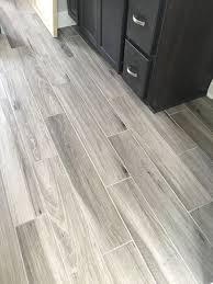 See more ideas about wood look wood in a bathroom or kitchen is surprising—one appliance or sink overflow and a traditional wood floor is ruined. Newly Installed Gray Weathered Wood Plank Tile Flooring Mudroom Foyer Ideas Bathroom Ideas Apartment Bathroom Design Grey Wood Tile Wood Plank Tile