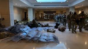 After national outrage in response to tens of thousands of national guard troops being sent outside to sleep in freezing parking garages, biden issued a statement begging the troops to be patient while he writes up the order to send them to much warmer climates in iraq and syria. National Guard Troops Sleep On Capitol Floor As House Nears Trump Impeachment Vote