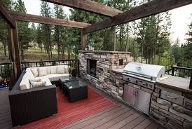 On the opposite side of this kitchen, and up a few steps, the fireplace warms a covered seating area. Outdoor Kitchen Designs Featuring Pizza Ovens Fireplaces And Other Cool Accessories