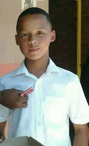 The late Alton Stewart receiving his Prefect Badge from Mr Timmet.