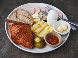 A true continental breakfast is what you'll find in europe (the continent). Continental Breakfast With Croissant Ham Cheese Egg Jam And Fruit Stock Photo Offset