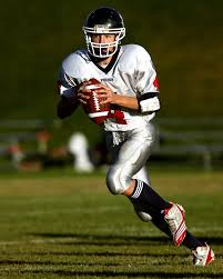 Holding is prohibited in most football leagues because it does not allow fair play of the game and increases the risk for injury. Man Holding Football While Running Free Stock Photo