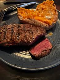 Ostrich steak and baked sweet potato. Delicious