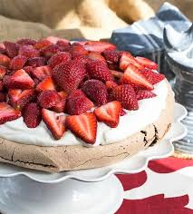 This ethereal crown of meringue, filled with cream and berries is a pavlova. Strawberry Topped Chocolate Pavlova That Skinny Chick Can Bake