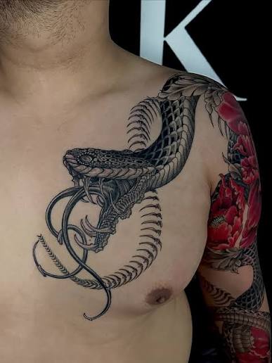 ⚔️🐍 Bold neo-traditional dagger and snake tattoo, brought to life with sharp lines, rich colors, and striking floral details. A perfect blend of power, danger, and elegance in one design. World-Class Tattoos