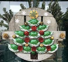 It's so enjoyable to decorate the home and do crafts with the kids. A Maryland Style Christmas Wreath Made With Crab Basket Lid And Lots Of Crab Shells Painted Green Red Pine Cones Christmas Wreaths Christmas Art Shell Crafts