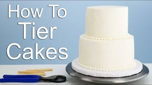 Remove baked cake from the pan by running a thin edged spatula around the sides to loosen it, then let it cool to room temperature before removing the parchment paper. The Easiest Way To Tier A Cake Youtube