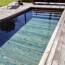 Swimming Pools With Wooden Textured Tiles And Real Wood Decking Landscapingcompaniesindubai Luxurylandscap Real Wood Decking Landscape Projects Swimming Pools