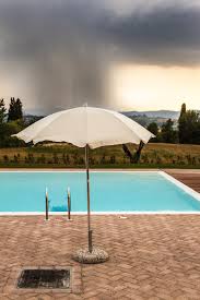 Wet the drained pool's walls with a hose. What To Do When Your Pool Overflows From A Storm Gold Medal Pools