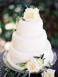 Simple White Buttercream Wedding Cake With White Roses And Greenery Wedding Cake Roses White Roses Wedding Simple Wedding Cake