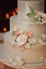 Three Tier Wedding Cake With Champagne Colored Luster Dust Floral Decorations Champagne Wedding Cakes Wedding Cake Champagne Color Champagne Wedding Colors