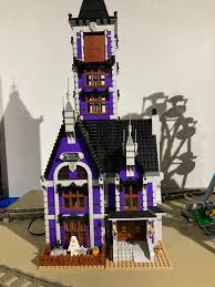 This purple headboard surrounds a circular window, helping to break up the color and add some light into the room. Haunted House In Dark Purple Lego