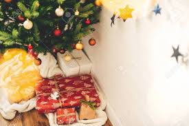 Maybe you would like to learn more about one of these? Stylish Christmas Gifts Under Christmas Tree With Red And Gold Baubles In Lights Presents Wrapped In Craft Modern Paper In Festive Scandinavian Room Space For Text Merry Christmas Stock Photo Picture And