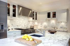 Incredible Kitchen With White Cabinets Accented With Nickel Hardware Alongside Arabescato Oro Vagli Marb Kitchen Marble Kitchen Design Best Kitchen Countertops