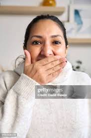Woman Covering Her Mouth With A Hand In Disbelief But Very Happy After  Receiving Some Good News High-Res Stock Photo