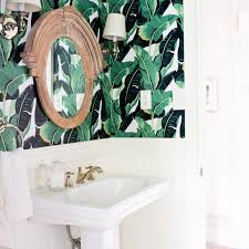 Dark hardwood floors contrast against the white, glass shower with tile walls. 15 Beautiful Small Bathroom Designs