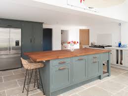 Pair grey kitchen cabinets with wood worktops and matt black finishes for a farmhouse kitchen decor. Jm Interiors Classic English Jm Interiors