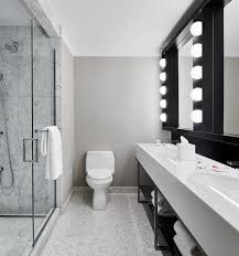 Empty luxury public rest room in a hotel the toilet of man with row of modern white ceramic urinals in public toilet or restaurant or hotel or shopping mall, interior. Kohler