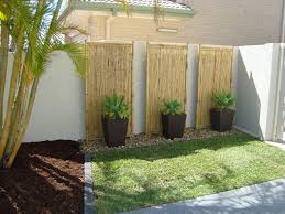 Tall Planters And Rocks Against Wall Lined By Stones Backyard Balinese Garden Bali Garden