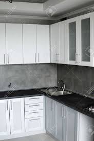 They are versatile and pretty at the same time. Modern Minimalism Style Kitchen Interior In Monochrome Tones Custom Kitchen With Grey White Facadesmdf And Dark Grey Countertop With Installed Kitchen Hood And Sink Modular Kitchen From Chipboard Stock Photo Picture And