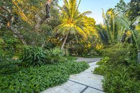 Entryway For A Lush Tropical Garden With Poured In Place Concrete And A Gravel Drive Complete With Plenty Of Privacy Landscape Design Tropical Garden Landscape