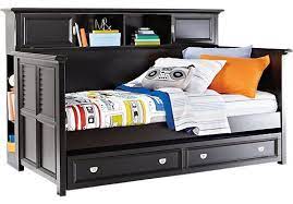 Storage trundle bed trundle beds are great to have but when you have a kids trundle bed with storage, you can save some space of the room too. Belmar Black 4 Pc Bookcase Daybed Bedroom Furniture Stores Rooms To Go Furniture Furniture